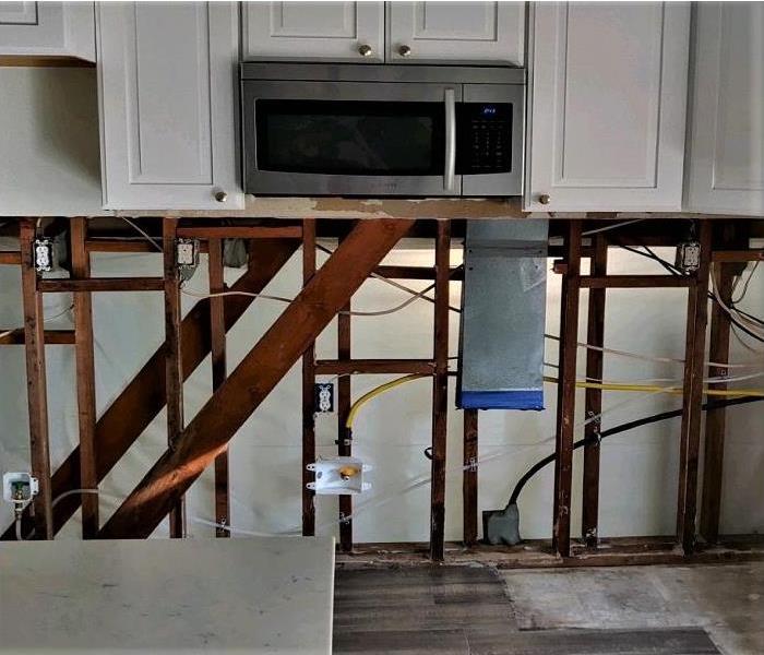 Cabinets have been torn out along with the stove and the surrounding area.  Only item left was the microwave above thte oven.