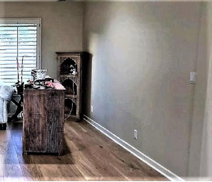 Living Room with hardwood floors with a white couch. 