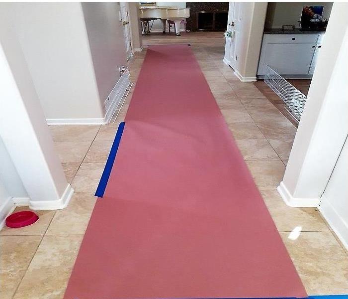 Halllway with heavy floor protection throughout the hallway.