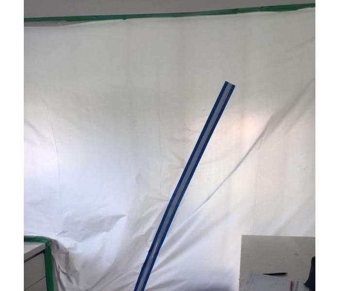 This is a plastic barrier separating the room that needs mold remediation also safety for the tenants to abstain from.